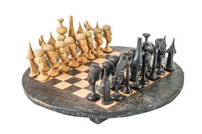 Lot 310 - An African carved wood chess set.