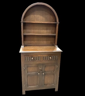 Lot 94 - An oak dresser with a dome plate rack top,...