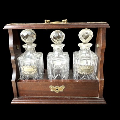 Lot 117 - A mahogany and brass tantulus with key.