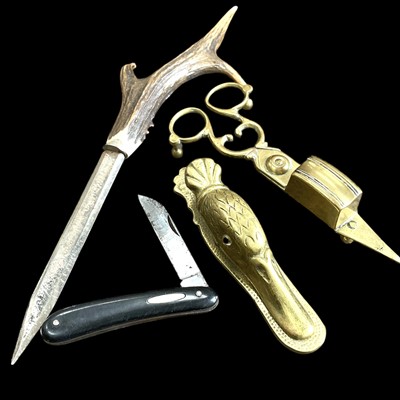 Lot 125 - A vintage brass candle wick trimmer/snuffer, a...
