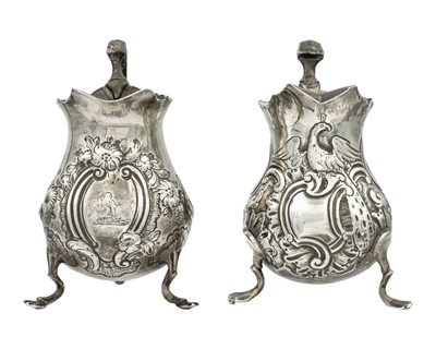 Lot 135 - Two George II silver embossed cream jugs, one by William Robertson, the other by Philip Goddard.