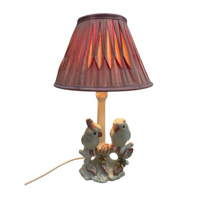 Lot 194 - A continental pottery table lamp modelled as a...