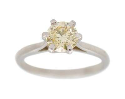 Lot 75 - A yellow diamond solitaire ring in platinum.