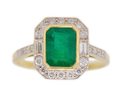 Lot 78 - An 18k gold emerald and diamond ring.
