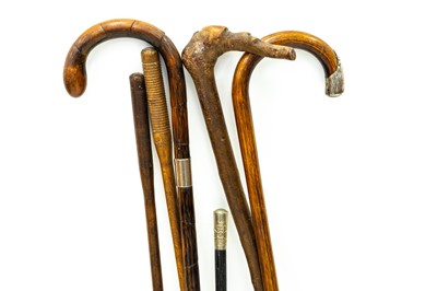 Lot 27 - Two silver mounted canes, another, a swagger stick, and two cleaning rods.