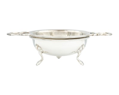 Lot 159 - A modern silver tea strainer and stand by Barker Ellis Silver Co.