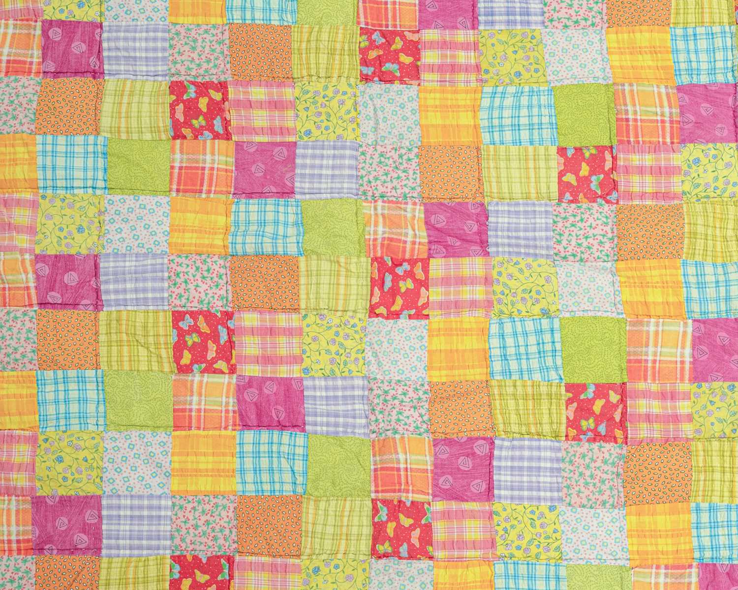 Lot 552 - A colourful patchwork quilt.