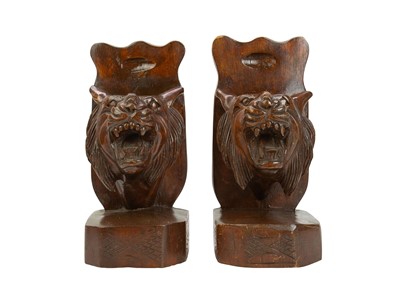 Lot 29 - A pair of Eastern hardwood bookends, carved with snarling tigers' heads.