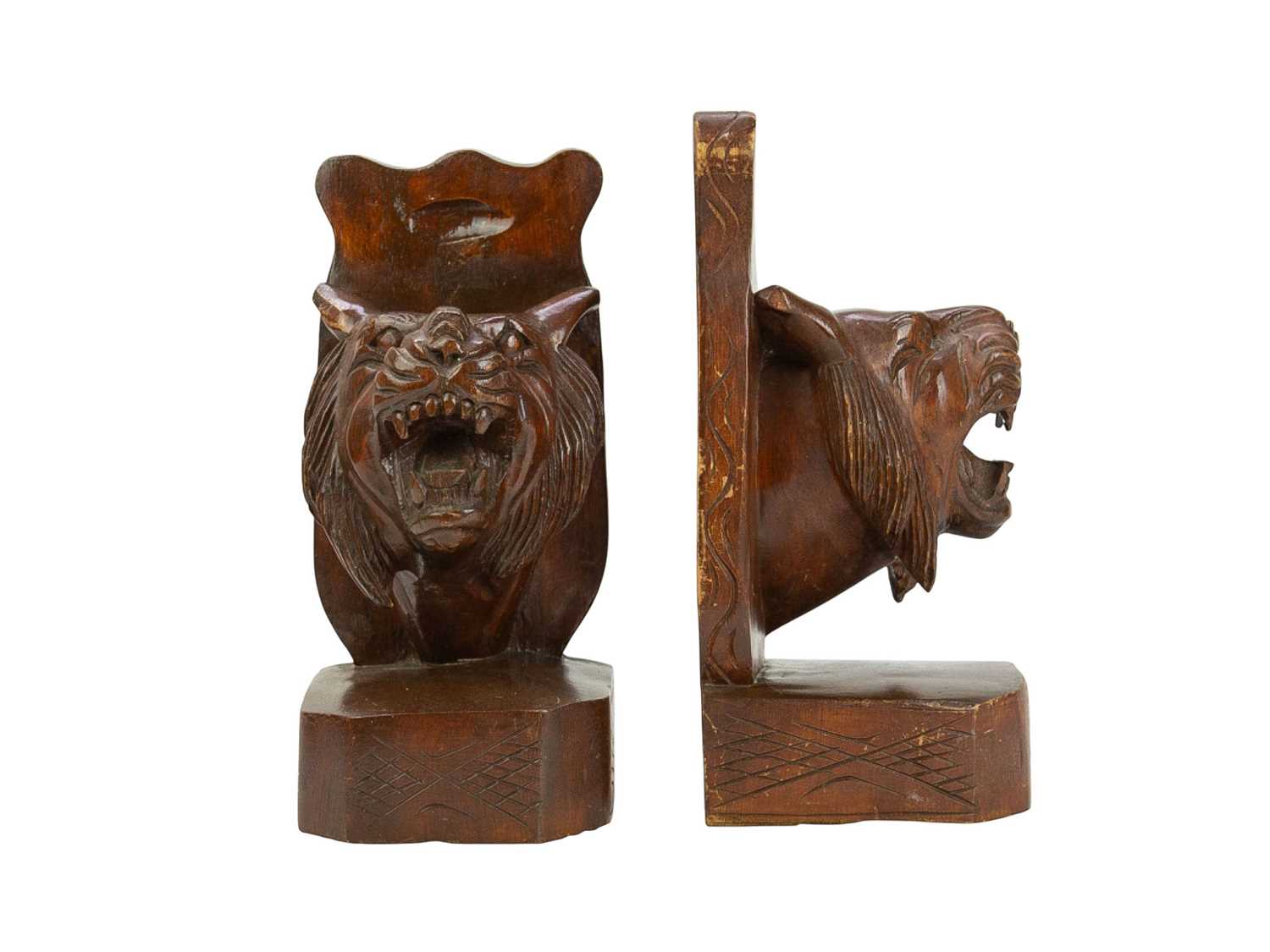 Lot 29 - A pair of Eastern hardwood bookends, carved with snarling tigers' heads.