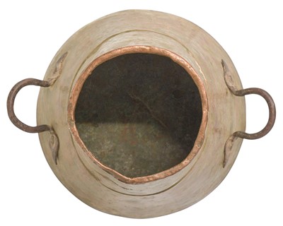 Lot 86 - An Eastern copper vessel with twin wrought iron handles.