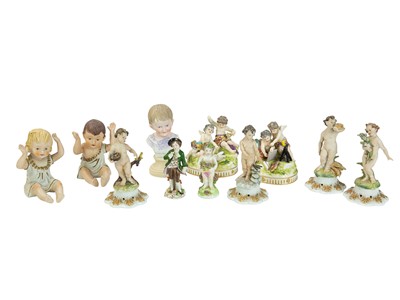 Lot 509 - A 19th century Derby type porcelain figure of a putto holding a basket of flowers.