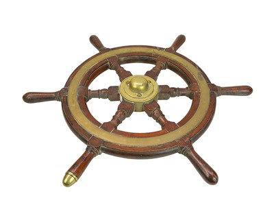 Lot 58 - A teak and brass mounted ship's wheel.