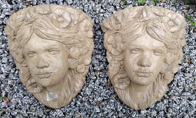 Lot 760 - A pair of reconstituted stone wall pockets cast as female masks.