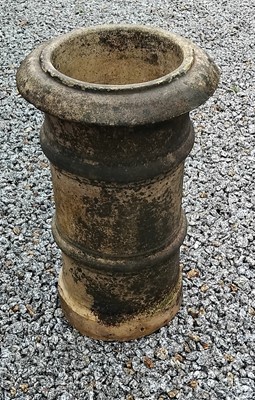 Lot 750 - A buff-coloured, rib-banded, chimney pot of cylindrical form.