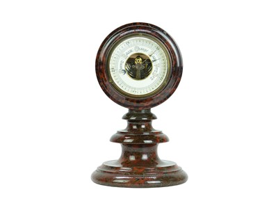 Lot 27 - A Cornish red serpentine cased aneroid barometer.