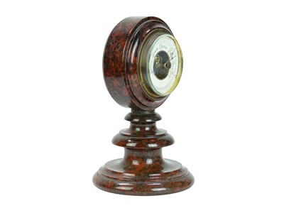Lot 27 - A Cornish red serpentine cased aneroid barometer.