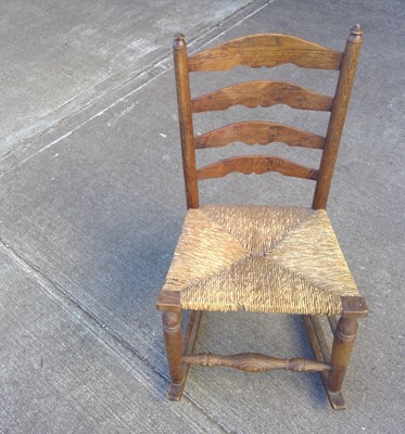 Lot 182 - A Ladderback Cord Seat Rocking Chair. The...