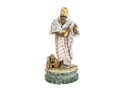 Lot 623 - A German glazed terracotta figure of an Arab musician.
