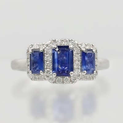 Lot 96 - A three-stone sapphire ring set in platinum.