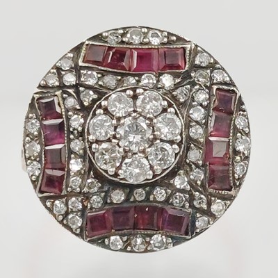 Lot 97 - An Art Deco-style rose gold and silver ring set with rubies and diamonds.