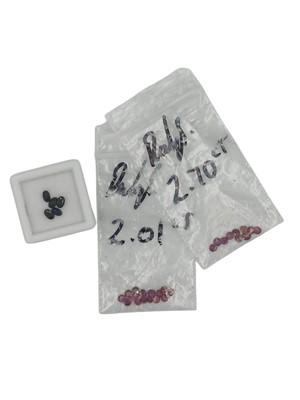 Lot 101 - A parcel of unmounted rubies with sapphires.