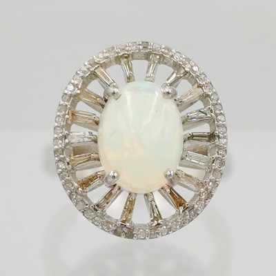Lot 103 - A silver opal and diamond dress ring.