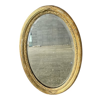 Lot 88 - A wood and gesso framed bevelled edge mirror....