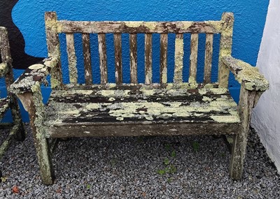 Lot 756 - A weathered, lichen covered, teak garden bench.