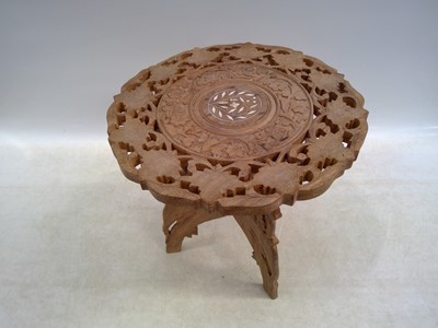 Lot 121 - A Folding Indian Carved Table. The Table is...