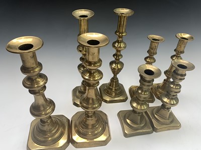 Lot 332 - Four pairs of Victorian brass candlesticks....