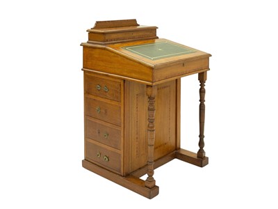 Lot 926 - A late Victorian walnut and satinwood banded Davenport desk.