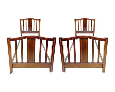Lot 950 - A pair of Edwardian mahogany and inlaid bed heads and ends.