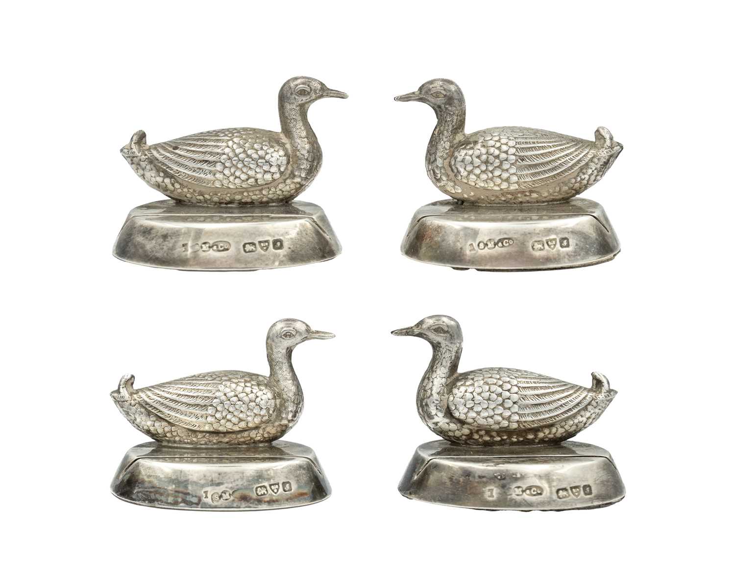 Lot 114 - SAMPSON MORDAN & CO - An Edwardian silver set of four menu card holders, modelled as ducks.