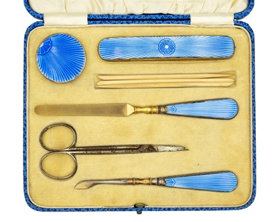 Lot 118 - HARRODS - An Art Deco silver and blue guilloche enamel manicure set, cased.