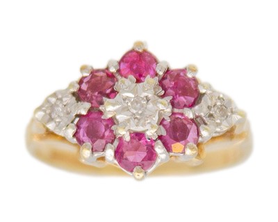 Lot 51 - A 9k gold ruby and diamond cluster ring.
