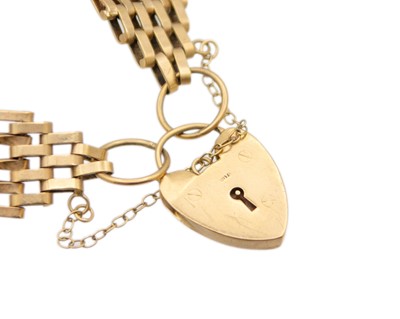 Lot 21 - A 9k gold gate link bracelet fitted with a padlock.