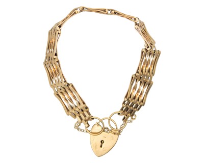 Lot 21 - A 9k gold gate link bracelet fitted with a padlock.