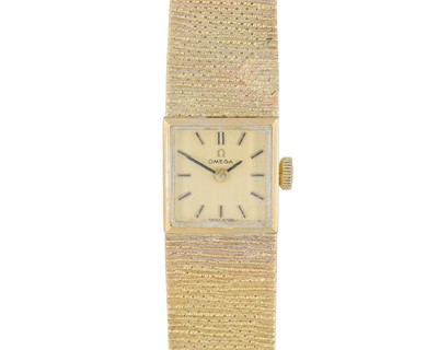 Lot 1034 - OMEGA - A 1970's 9k lady's manual wind bracelet wristwatch.