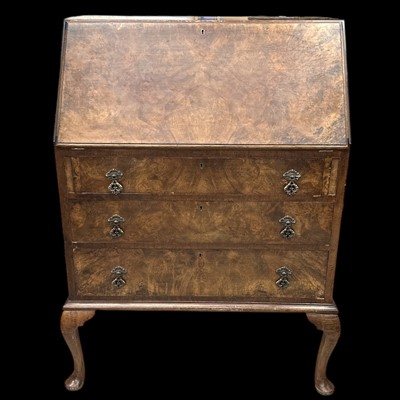 Lot 169 - A walnut venier three-drawer writing bureau,...