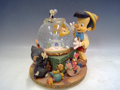 Lot 180 - A Walt Disney Pinocchio Snow Globe. The Globe...