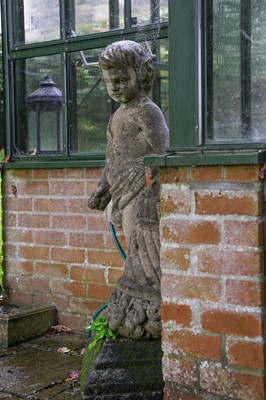 Lot 751 - A reconstituted stone figure of a putto.