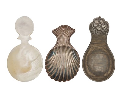 Lot 63 - An Arts & Crafts pewter caddy spoon by John H Green, a mother-of-pearl caddy spoon, and one other.