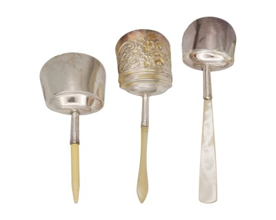 Lot 11 - A selection of three George III silver caddy spoons with scoop-shaped bowls.