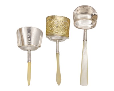 Lot 11 - A selection of three George III silver caddy spoons with scoop-shaped bowls.