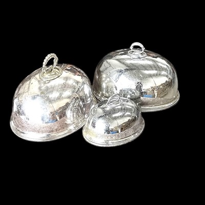 Lot 57 - Three Victorian silver plate meat covers the...