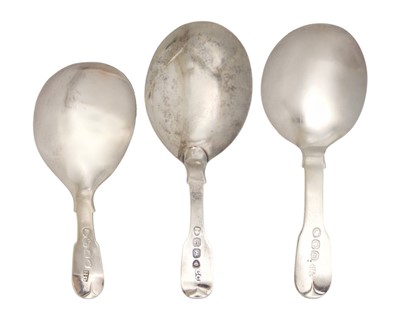 Lot 24 - A selection of three Georgian silver caddy spoons with bright cut decoration.