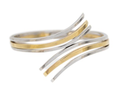 Lot 61 - A 14k bi-colour gold hinged bangle.