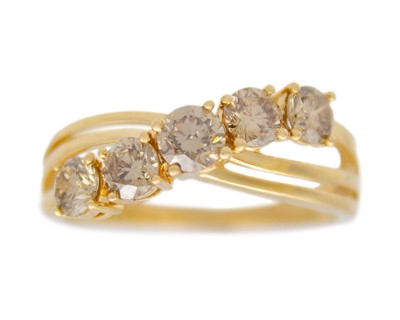 Lot 88 - An 18k gold five-stone champagne diamond ring.