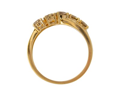 Lot 52 - An 18k gold five-stone champagne diamond ring.