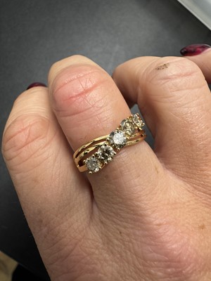 Lot 52 - An 18k gold five-stone champagne diamond ring.